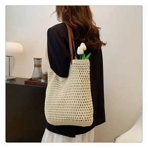 Detail of cream crochet knit tote bag with brown leather straps and tulip decor