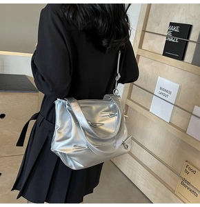Detailed macro view of silver metallic PU tote bag with elegant bow accents and dual straps