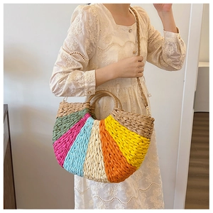 Detail of multi-color woven straw handbag with colorful panels and adjustable strap
