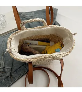 Detailed interior of straw woven handbag with drawstring lining and daily essentials