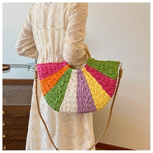 Detailed close-up of colorful straw woven handbag with round handle and woven strap