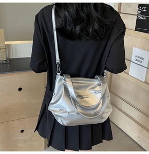 Detailed view of silver metallic PU leather tote with chic bow knots and pleated design