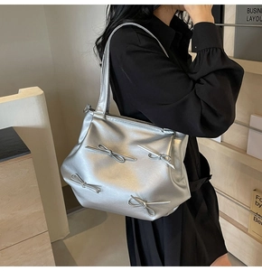 Detail of silver matte PU shoulder bag featuring four decorative 3D bows for women