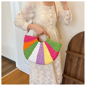 Detail of colorful woven straw handbag with wooden handle and striped half-moon design