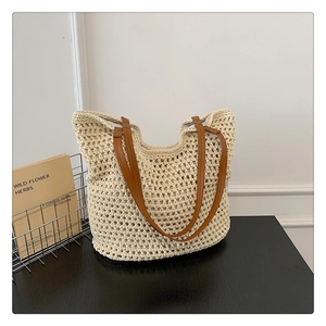 Fashionable beige knit tote bag with brown leather handles and hollow mesh texture