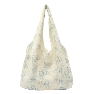 Minimalist cream lace tote bag featuring intricate light blue butterfly embroidery