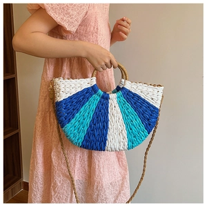 Detailed close-up of a tricolor striped straw handbag with round handles and metal hardware