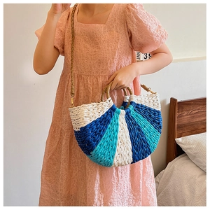 Macro detail of half-moon straw woven bag with contrast blue and cream stitch pattern