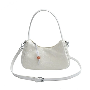 White floral jacquard crescent handbag with beaded charm and adjustable strap
