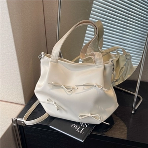 Chic beige PU leather tote bag with bow accents and adjustable shoulder strap for women