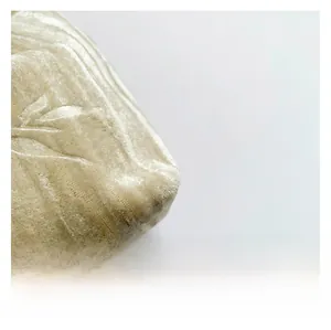 Close-up of premium champagne velvet fabric with pleated texture and silky gloss finish