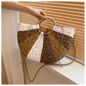 Handwoven straw tote bag with half-moon design and adjustable strap for summer holidays