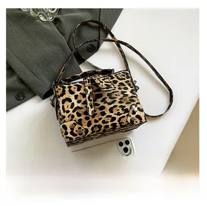 Detail of mini faux pony hair leopard print box bag with silver rivets and top handle