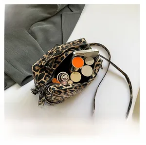 Leopard print Boston bag showing interior capacity for phone, lipstick and perfume