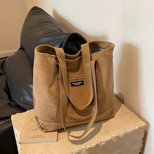 Retro brown canvas tote bag with reinforced handles and Noco collection patch detail