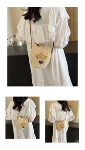 Detail of woven straw bucket bag with colorful handmade 3D floral accents and leather strap
