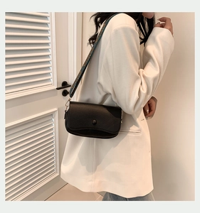 Detail der schwarzen Crossbody-Tasche aus PU-Leder mit buntem Retro-Geometrie-Gurt