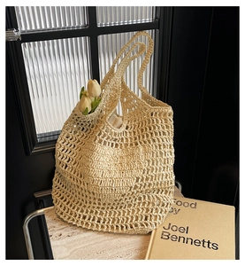 Detailed macro view of beige handmade woven cotton rope tote bag with diamond mesh pattern