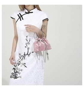 Detail of pink velvet bucket bag showing silk texture, drawstring and silver metal handle