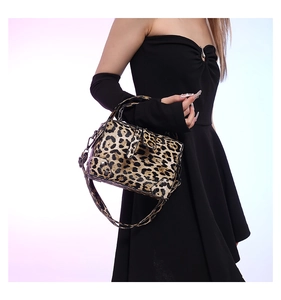 Detailed side view of a leopard print PU leather handbag with metal rivets and strap