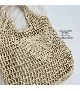 Detailed close-up of woven straw handbag featuring honeycomb mesh and soft fabric lining