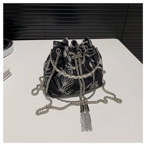 Chic drawstring bucket bag with black and white floral print and silver chain strap