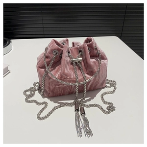 Pink velvet drawstring bucket bag with silver chain strap and fringe details