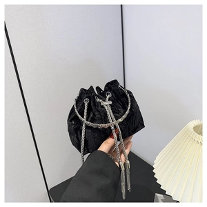 Chic black velvet bucket bag with silver round handle and metal chain shoulder strap