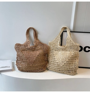 Detailed close-up of handmade straw woven tote bags in brown and beige colors