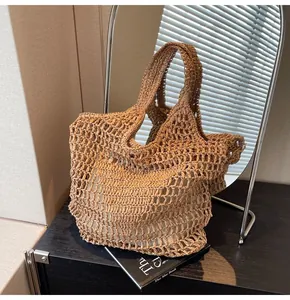 Close-up of handmade hollow woven straw tote bag with fabric lining on minimalist cabinet