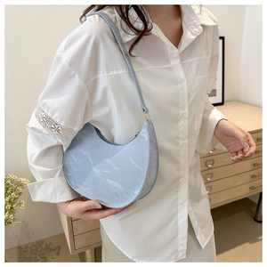 Detail showing a light blue crescent hobo bag with unique wrinkled leather and gold hardware