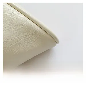 Close-up of premium cream PU leather material showing soft texture and natural wrinkles