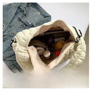 Large off-white quilted cloud tote bag showing spacious interior with daily essentials