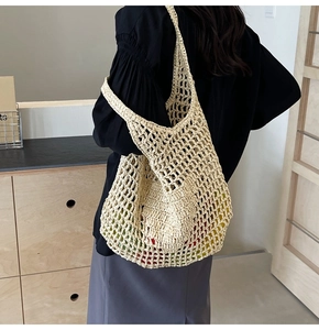 Close-up of cream white hand-woven mesh tote bag with fruit inside for summer look