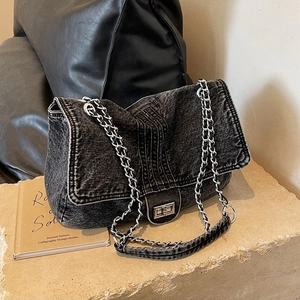 Trendy dark washed denim crossbody bag with silver chain strap and metal swivel lock closure