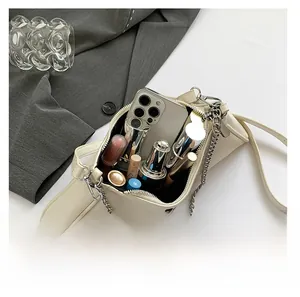 Detail view showing large capacity of the beige PU leather shoulder bag with chain strap