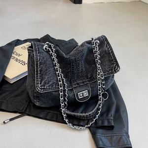Chic dark gray denim crossbody bag with silver chain strap shown from a 45-degree angle