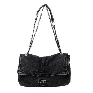Fashionable black denim crossbody bag with silver chain strap and flip-top buckle closure