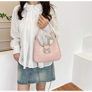Pink crocodile pattern shoulder bag featuring a sparkling rhinestone bow buckle and chain