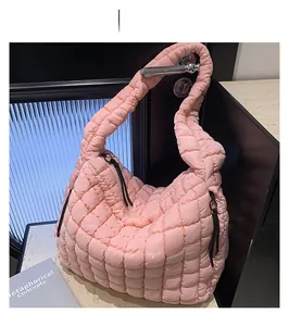 Close-up of pink quilted cloud bag showing secure zipper closure and puffy nylon texture