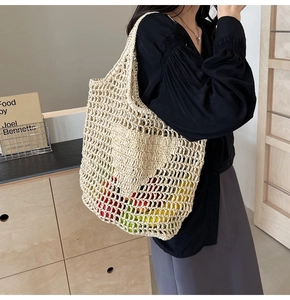 Detail of handmade straw woven mesh bag filled with fresh fruits showing its large capacity