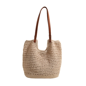 Straw woven tote bag for women with brown faux leather handles and hollow mesh design