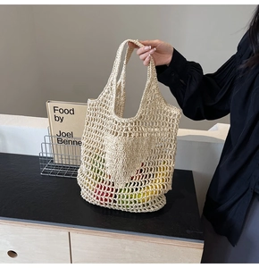 Detail of handmade cream crochet tote bag with hollow woven patterns for summer travel