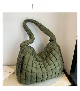 Detailed close-up of dark green quilted cloud bag with padded nylon texture and chic pleats