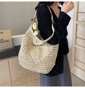 Close-up of handmade beige woven straw net bag with large hollow mesh texture details