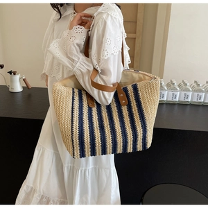 Detail of vintage striped woven tote bag with brown leather handles and spacious interior
