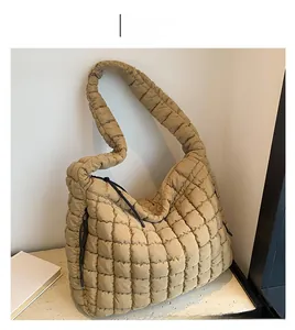 Detailed close-up of khaki quilted cloud tote bag featuring soft pleated texture and side straps