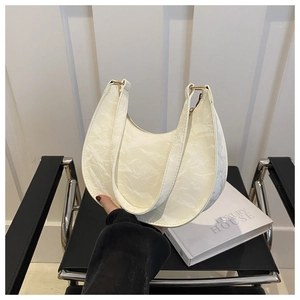 Minimalist white croissant moon handbag in pleated faux leather with gold buckles
