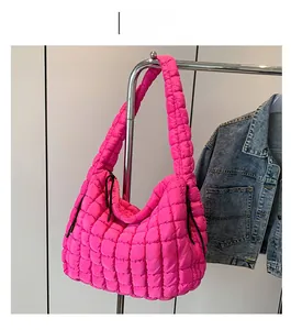 Detail of rose red quilted puffer tote bag with puffy cloud texture and zipper