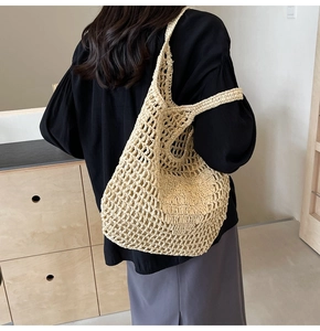 Detail of hand-woven beige straw tote bag featuring a lattice mesh design for summer style